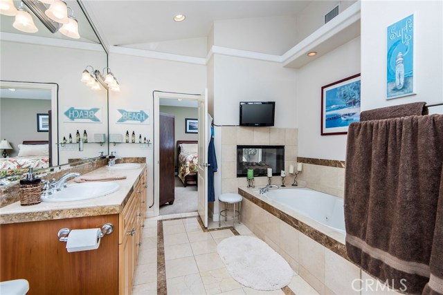 Master bath with tub and separate shower, two sinks.