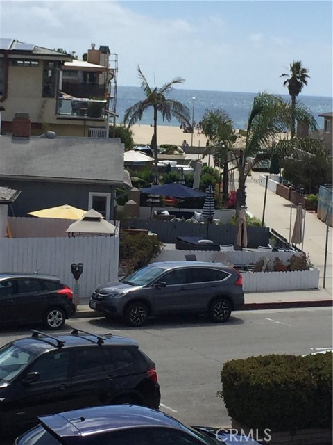 Walkstreet view from 2nd floor of sand, surf, and volleyball.