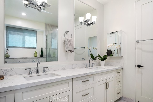 The primary bathroom has double vanity/sinks, quartz countertops, a separate WC...