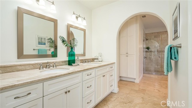 The spa like remodeled master bathroom with double sinks.The walk in closet is to the right.