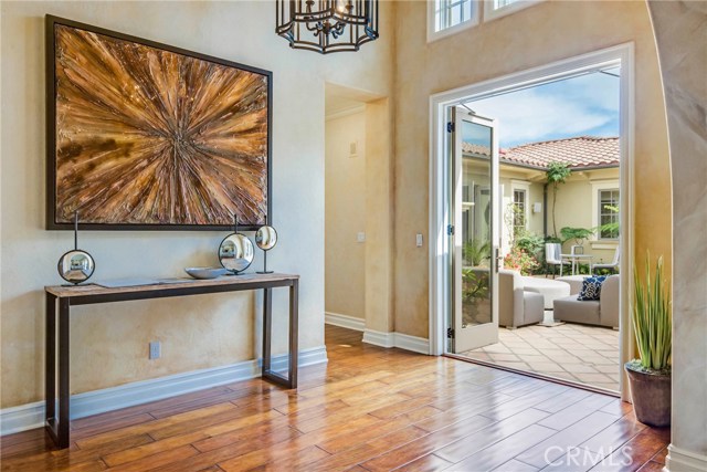 Grand entrance with high ceilings and open doors to the center atrium allowing the fresh ocean air to circulate through the house.