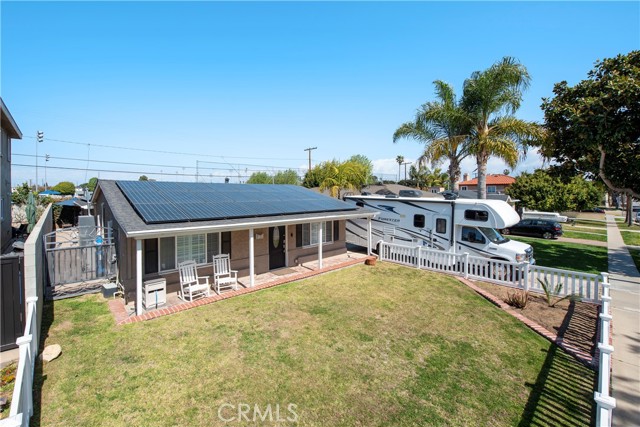 Front yard view showing RV parking, picket fence and solar panels
