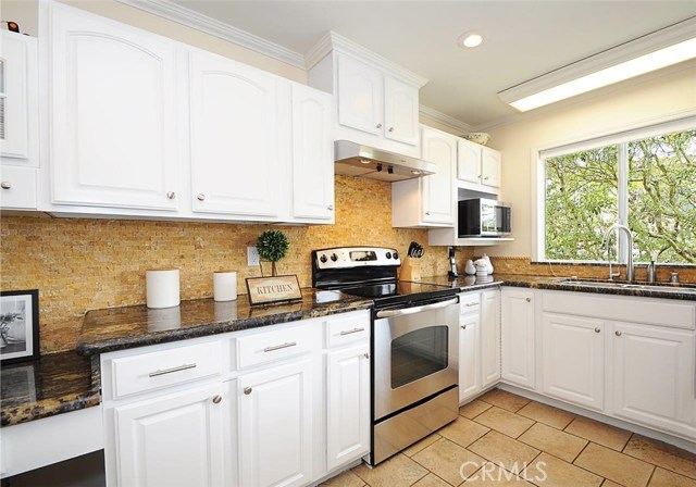 Freshly updated kitchen with stainless appliances and beautiful tree view from the kitchen sink.