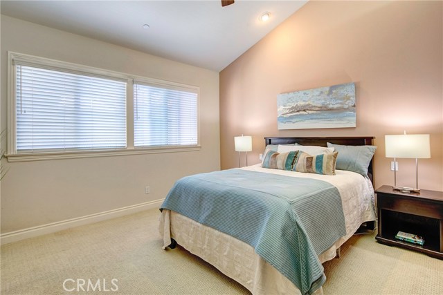 Peaceful and quiet master bedroom suite with vaulted ceilings and ceiling fan.