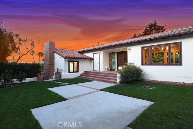 Courtyard area near front entry shows a peak of the city lights view toward the rear of the house.