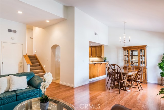 Bright living areas - as seen from living room - dining room connected to kitchen via breakfast bar.  Garage access at the left, patio is off dining room, to the right.