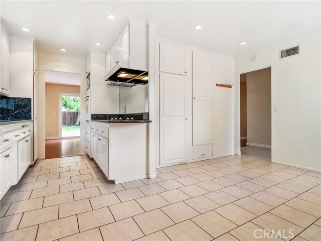 The kitchen with a large breakfast nook and ample cabinetry and pantry space.