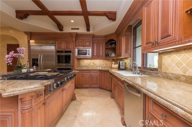 Another view of this gorgeous kitchen with granite counters & Travertine floors.  Door to the left leads conveniently into the 3 car garage.