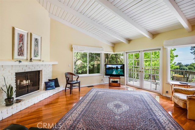 living room looking out to the French doors opening up to the view deck