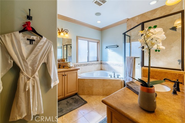 This luxurious master bathroom features dual vanities, a soaking tub, and extra spacious shower.