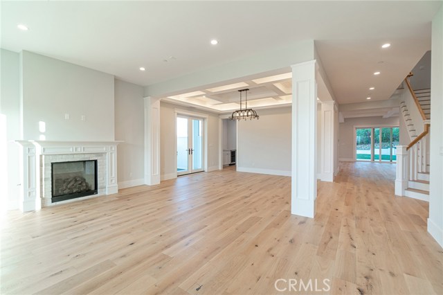 View from the front door of living room fireplace and dining room.