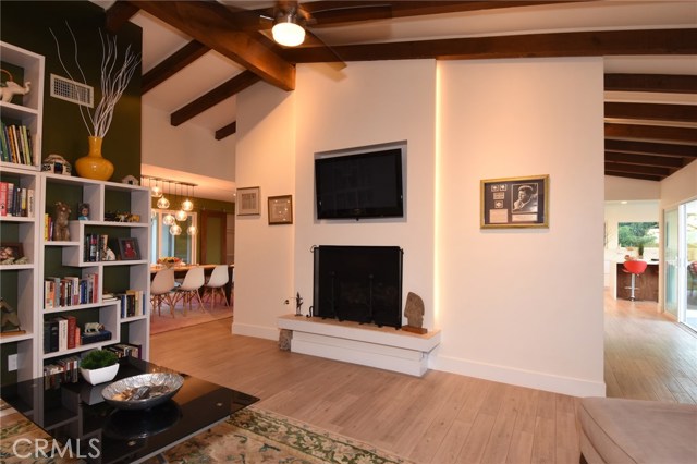 Last family room shot! Beautiful fireplace and TV nook above. Dining room and kitchen are beyond