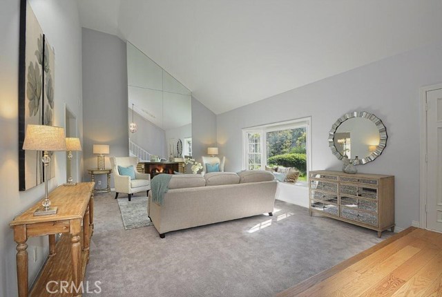 Formal Living Room off Entry with Vaulted Ceilings, Fireplace and Bay Window.