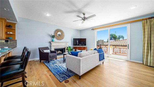 Family room with gas fireplace in background.  A deck the length of the house to the right.