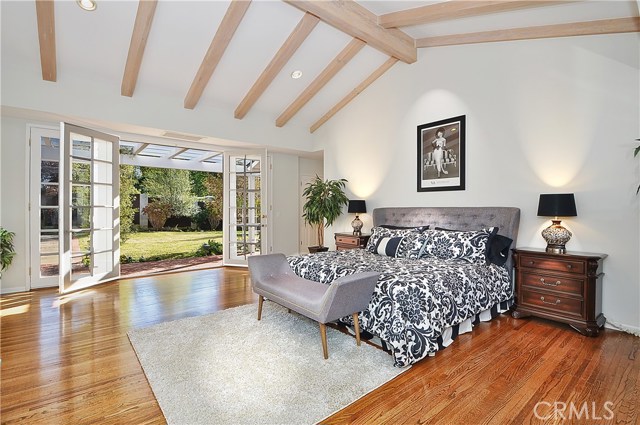 Spacious Master Bedroom with French Doors Opening to Garden