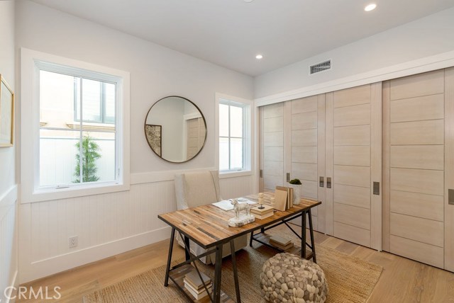 Main floor bedroom is shown here as a home office, also suitable for a private guest suite, gym, library, et...