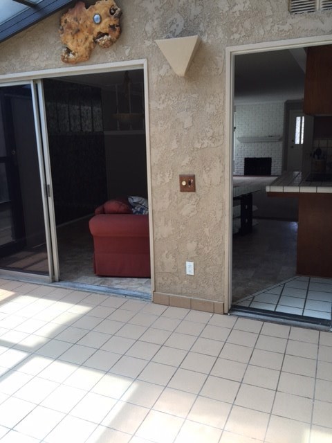 Front house sunroom looking into kitchen and dining room