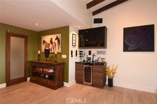 Close up of the wine bar area.  Barn slider door to the left opens to the mud room and garage beyond.