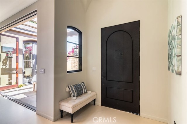 View of front door and al fresco dining patio