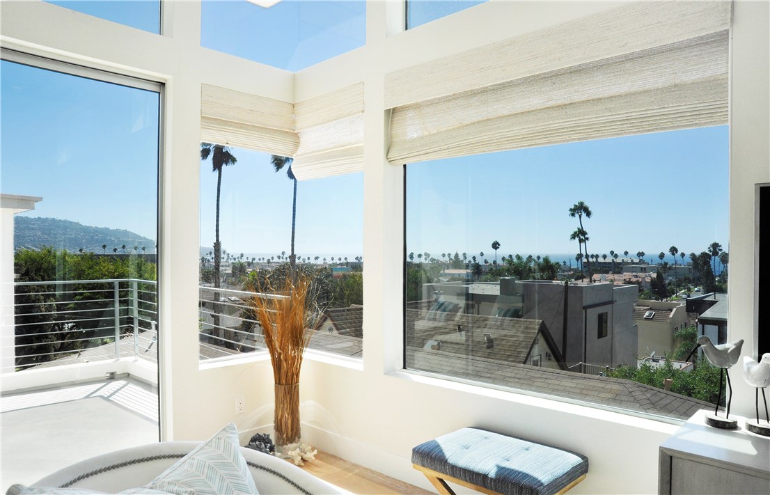 Living area with with Palos Verdes and ocean views has remote controlled shades