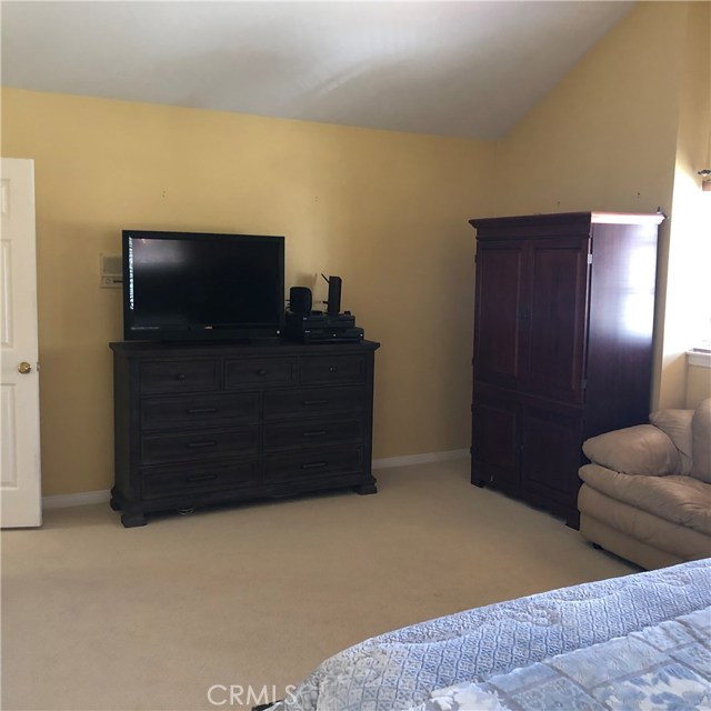 Another view of the master bedroom space with cathedral ceilings...