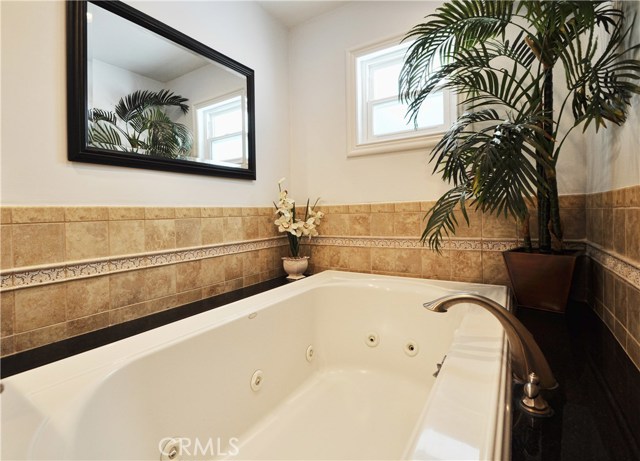 This full bath features a jacuzzi tub and steam shower.