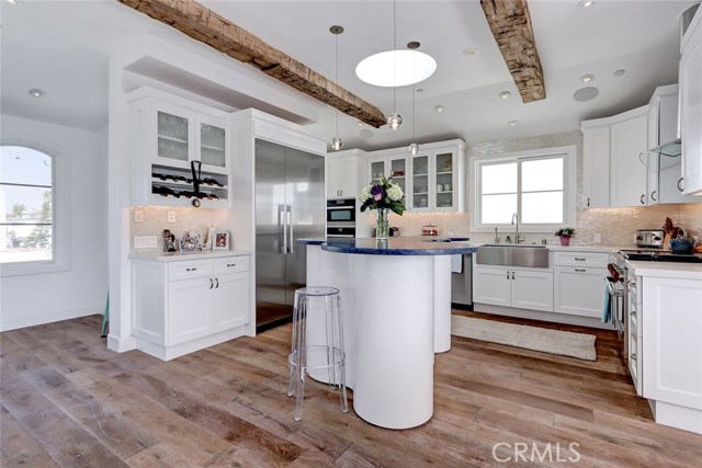 Gourmet kitchen with unique center island topped with custom blue glass counter