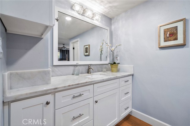 Beautiful master bath vanity with marble countertops and crystal light fixture.