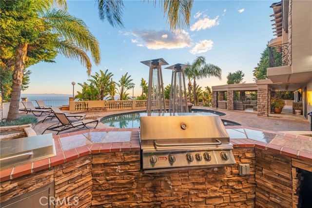 Imagine entertaining family and friends from your this AMAZING backyard! Inspirational and positively sweeping ocean views while you swim, soak in the spa, get a tan or simply enjoy the shade of the covered patio with built-in flat screen television, recessed lighting and surround sound.