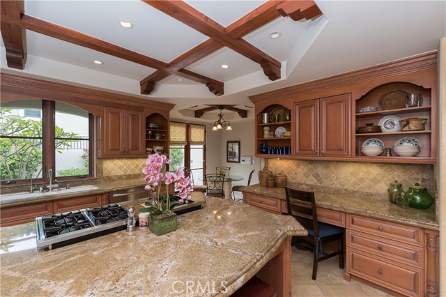 Another kitchen view with large casual eating area in the background, and wonderful desk area too!