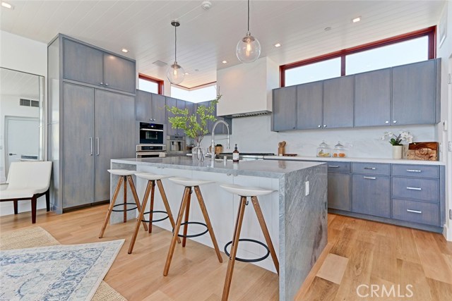 Center island kitchen with Thermador appliances, including built-in coffee maker