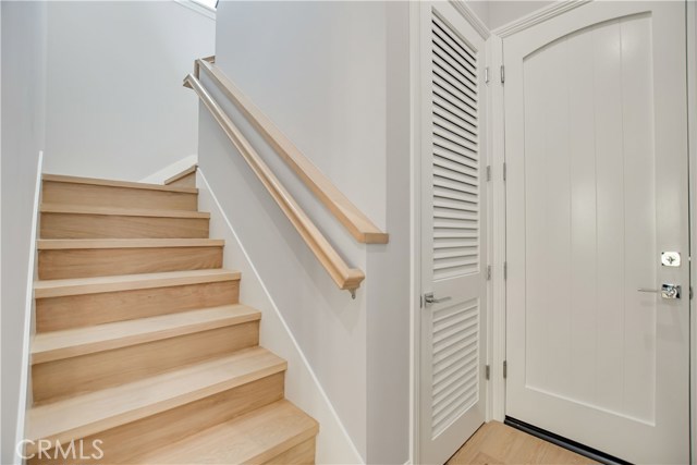 STAIRCASE TO 2ND LEVEL / ENTRY TO GARAGE