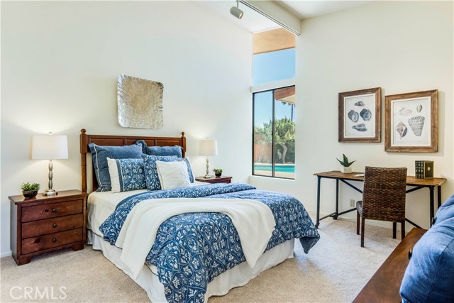 2nd bedroom with high ceilings and view