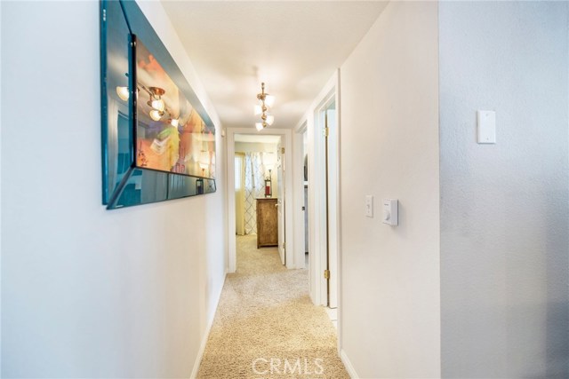 Hallway leading to the bathroom and two bedrooms