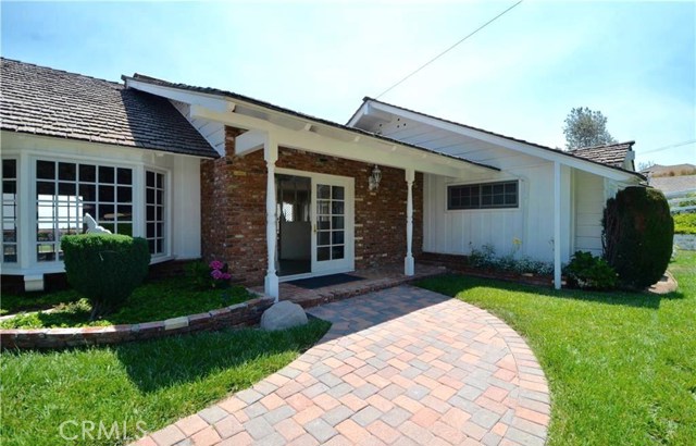 Front view and covered patio leads to the double door entry.