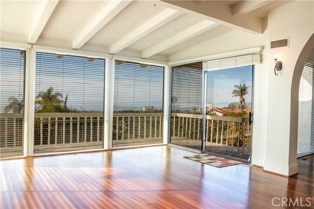 Formal living room with Brazilian Cherry hardwood floors and windows facing the ocean for sunsets all year long.