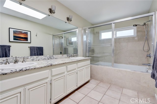 Striking master suite bath with dual sinks and stone countertops.