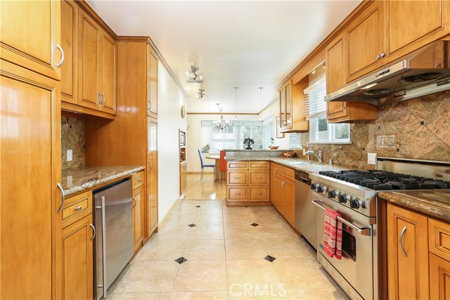 Beautiful kitchen with wooden cabinets, granite counters and high end appliances.