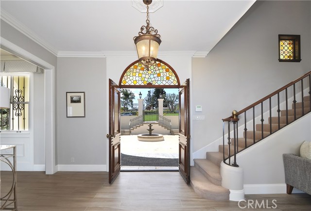 Double door entry looking out to front porch and front courtyard's fountain.