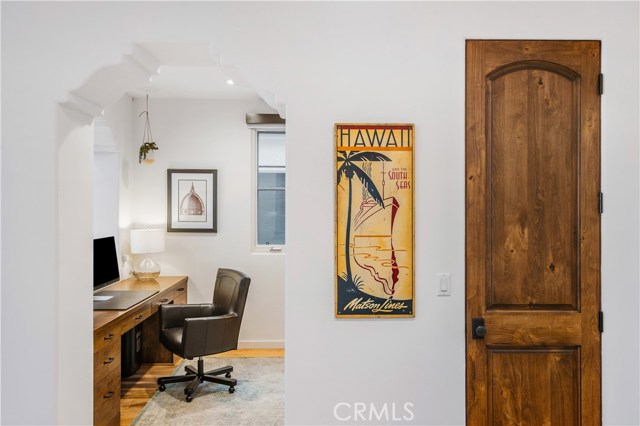 Just off the kitchen sits an open office which looks straight to the Pacific Ocean and features a built-in desk and cabinetry.