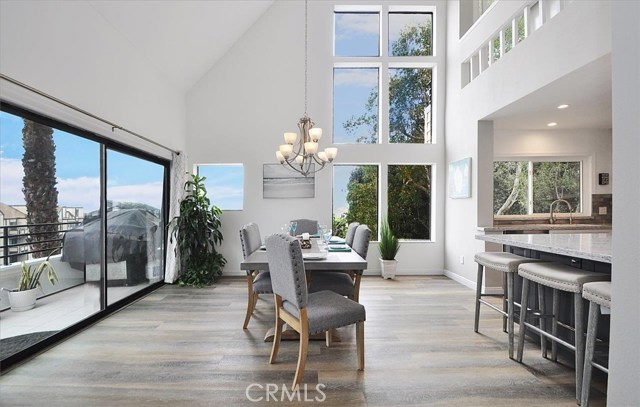 Dining area with soaring ceilings and plenty of light