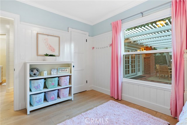 Bedroom #2 - With a view into the backyard, custom wainscoting, Emtek oil rubbed bronze hinges and door knobs, lighting by Rejuvenation, Wide plank French oak flooring, Lutron dimmer light switches.