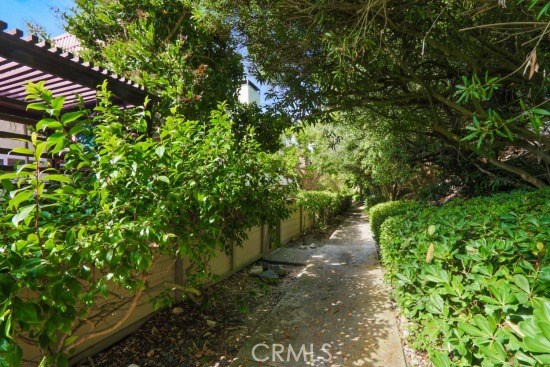 Lushly landscaped walkway behind private patio