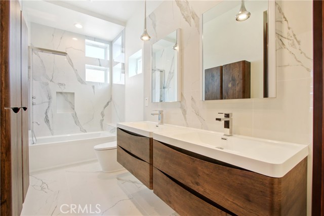 Jack and Jill Bathroom with double-glazed porcelain tile and floating vanity