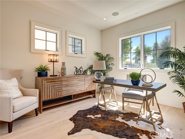 Main level office adjacent to entry and located off of living room.