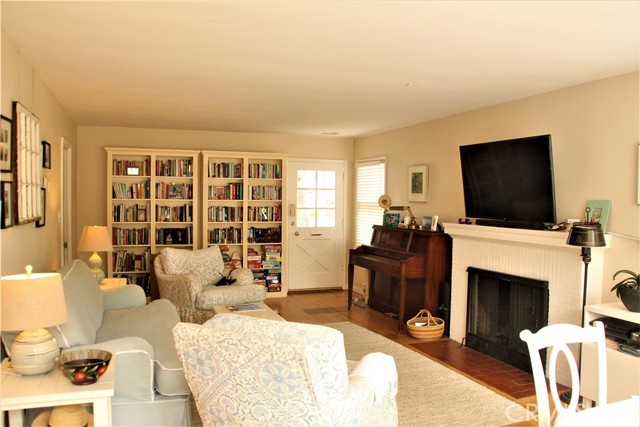 Original oak hardwood floors and simple brick fireplace in living room. Front door is facing North. Bookshelves are not built-in.