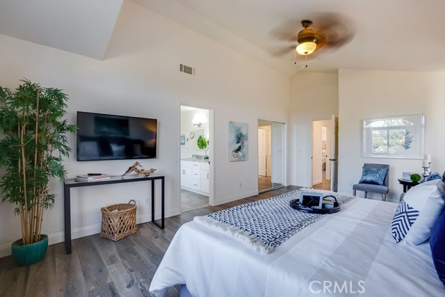 Large Primary Bedroom with HUGE walk-in closet, vaulted ceilings, and ceiling fan