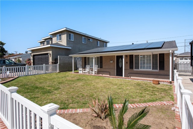 Large grass yard and even a white picket fence!