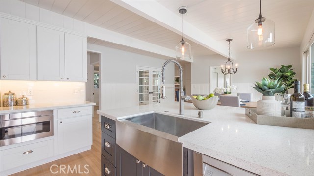 Kitchen with island, microwave drawer and farmhouse sink