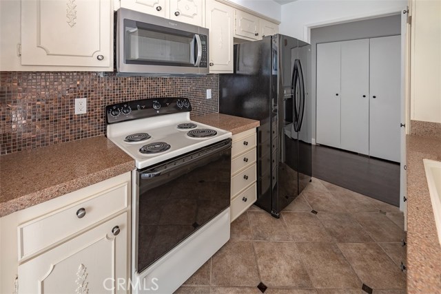 Kitchen facing entry hall with closets